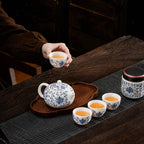Blue lotus porcelain Gongfu Chinese tea set with teapot, teacups, tea canister, and tray on a wooden tea table