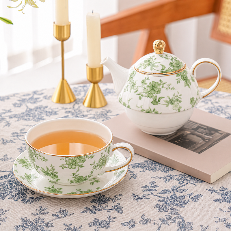 Stacked green floral teapot cup and saucer with gold trim