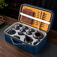 Portable purple clay Chinese tea set organized inside a blue travel case with tea tray and accessories