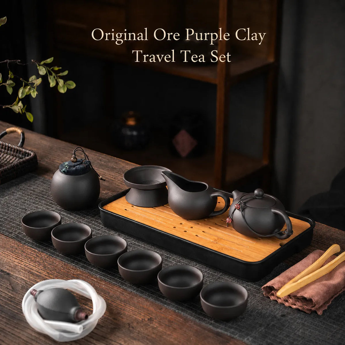 Portable purple clay Gongfu Chinese tea set with teapot, cups, tea caddy, strainer, tea tray, and bamboo tongs