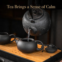 Purple clay Chinese tea set brewing on a bamboo tea tray for a calm Gongfu tea moment